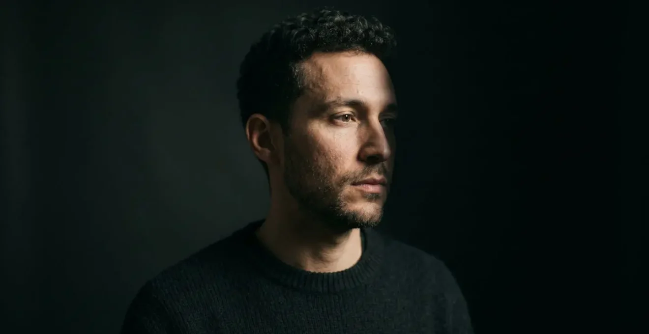 Dramatic side-lit portrait setup showing strong light-to-shadow contrast with single light source