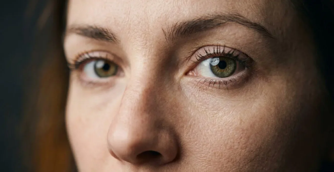 Extreme close-up of subject's eyes making direct confrontational eye contact with viewer