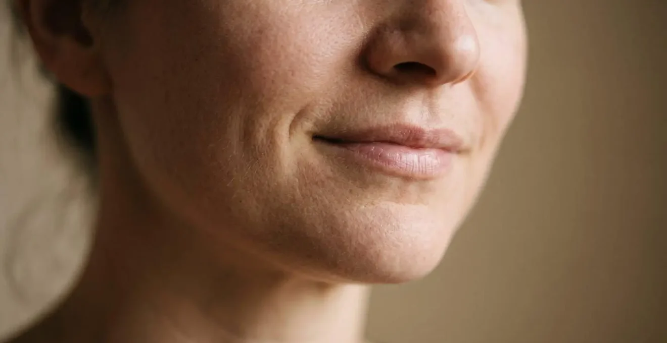 Subtle facial expression captured in soft natural light showing enigmatic emotional ambiguity
